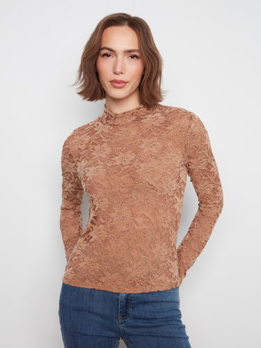 The mock neck top showcases a beautiful flocked lace design, creating an elegant and sophisticated look. By Charlie B.