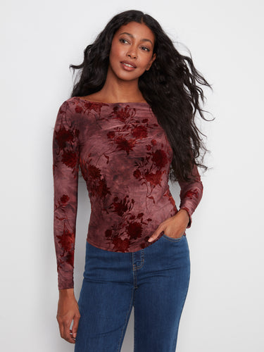 Elegant top with a flattering boat neckline, showcasing a floral pattern in rich hues. Perfect for any occasion. By Charlie B.
