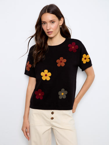 Black sweater with floral embroidery, featuring a classic crew neck design by Charlie B.