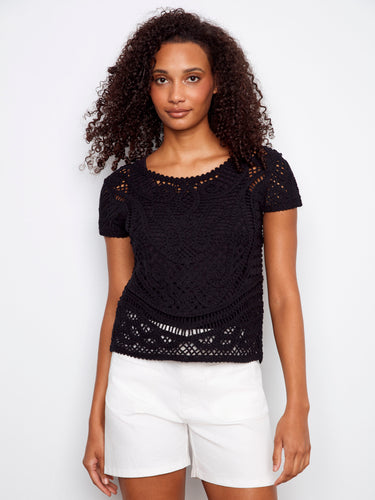This black crochet top features a stylish button-down front, offering a chic look for any occasion by Charlie B.