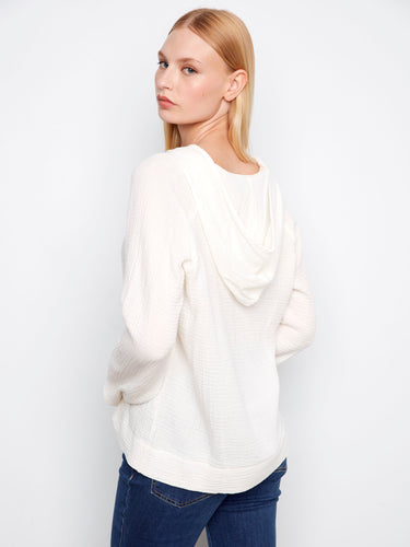 The charming top showcases a relaxed fit with a hooded style, crafted entirely from breathable cotton fabric by Charlie B.