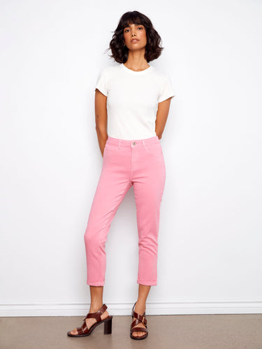 Pink cropped pants with a slim fit silhouette, featuring cuffed hems for added style. By Charlie B.