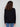 Classic black sweater with subtle side slits on sleeves, adding modern flair to a timeless piece by Charlie B.