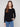 Elegant black sweater featuring a boat neck design, ideal for versatile styling by Charlie B.