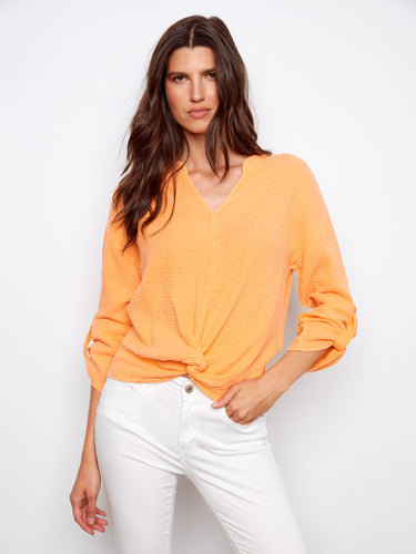 Orange top with a stylish front knot detail, enhancing its casual elegance. Made from 100% cotton for breathable comfort by Charlie B.