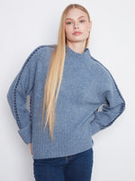 Blue sweater with a mock neck featuring long raglan sleeves, adding a cozy touch to your wardrobe by Charlie B.