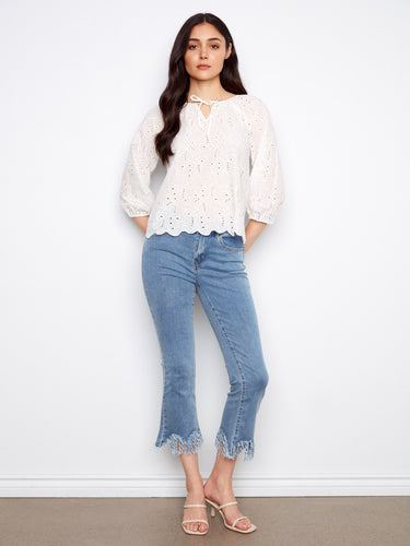 Elegant white cotton blouse with 3/4 sleeves and elastic cuffs, adorned with intricate eyelet patterns by Charlie B.