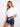 White cropped jacket featuring front chest pockets, styled with denim shorts and a white tee by Charlie B.