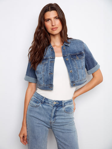 This chic cropped denim jacket showcases short rolled sleeves and chest pockets, ideal for layering by Charlie B.