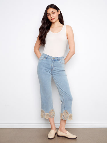 Cropped flare jeans in light blue with a regular rise, showcasing intricate lace hem details for a chic look by Charlie B.