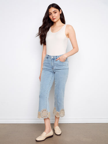 Light blue cropped denim with flared legs and elegant lace detailing at the bottom for added flair by Charlie B.