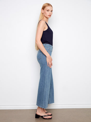 Designed with a raw hem, these denim jeans add an edgy touch to your casual outfits by Charlie B.