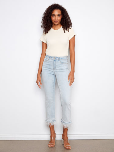 Light blue jeans with a flared leg and frayed details, featuring a regular rise and stretch denim for comfort by Charlie B.