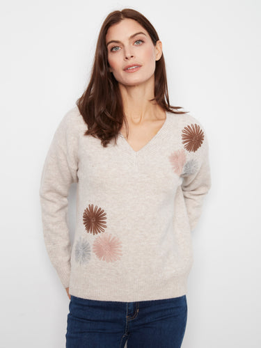 Sweater with a V-neck and charming floral embroidery, offering a stylish touch to your outfit. By Charlie B.