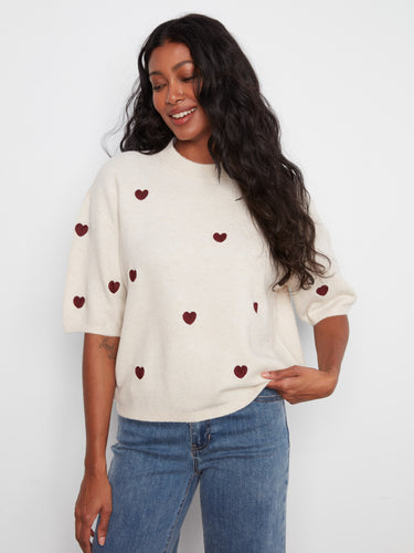 This knit sweater features a charming mock neck design, adding a touch of sophistication to your casual wardrobe. By Charlie B.