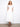 White dress with V-neck and elastic empire waist, featuring hidden pockets for practicality by Charlie B.