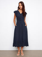 The dress features an empire elastic waist, adding a flattering silhouette for various body types. By Charlie B.