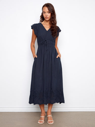 The dress features an empire elastic waist, adding a flattering silhouette for various body types. By Charlie B.