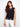 Black crochet top with a crew neckline, showcasing intricate floral patterns for a chic look by Charlie B.