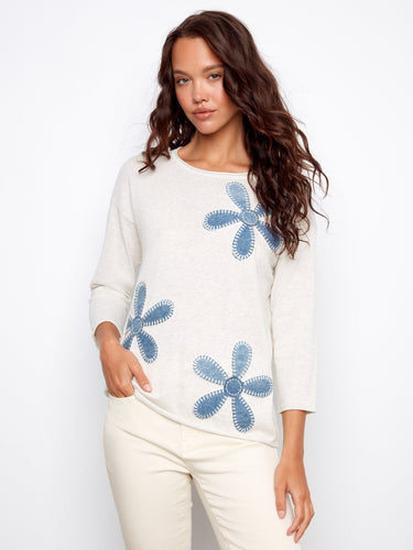 Heather Oat sweater with a classic crew neckline, adorned with denim patches and floral embroidery, crafted from 100% cotton by Charlie B.