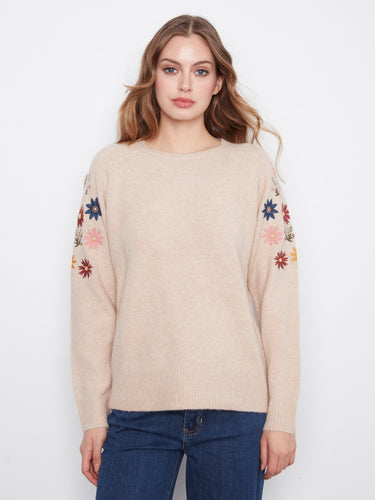 This sweater features a crew neckline, adding a classic touch to the floral embroidery design. By Charlie B.