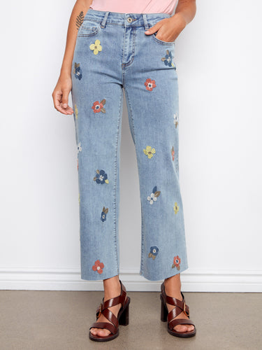 These stretch denim jeans feature vibrant floral embroidery, offering both comfort and style by Charlie B.