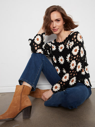 Experience the artful craftsmanship in our daisy-adorned, scallop-hemmed crochet blouse that exudes elegance. By Charlie B.