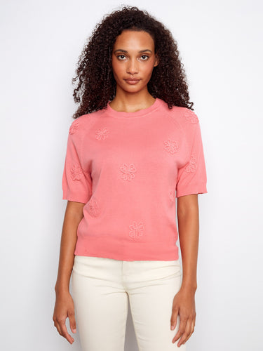 Pink top featuring a crew neckline, highlighted by delicate applique embroidery for a touch of elegance. Crafted in 100% cotton by Charlie B.