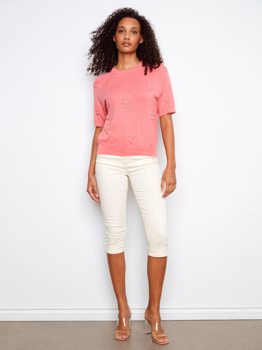 This pink top showcases raglan sleeves, offering a relaxed fit and style. Made from soft 100% cotton fabric by Charlie B.