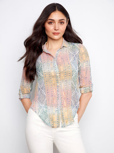 Adorned with gold print details, this shirt adds a touch of glamour to any outfit. The subtle shimmer enhances its appeal. By Charlie B.