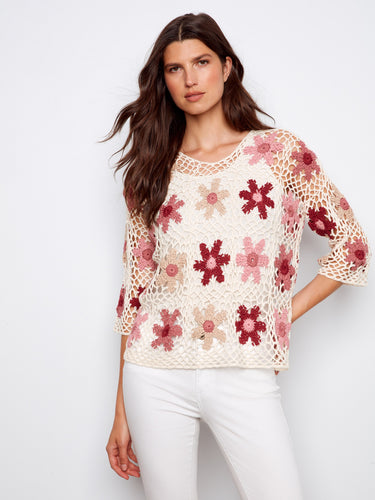 Stylish handcrafted crochet top with exquisite floral patterns, ideal for a fashionable ensemble by Charlie B.