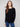 Black knit sweater featuring a boat neck design, complemented by long ribbed sleeves for a sleek look by Charlie B.