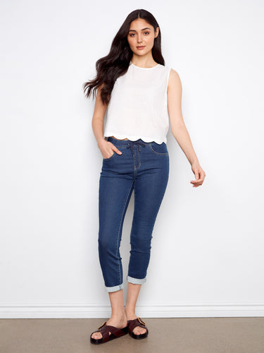 The scallop hem adds a touch of elegance to this versatile sleeveless top, making it a chic addition to your wardrobe by Charlie B.