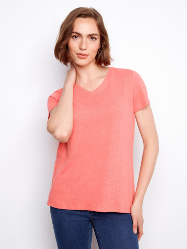 This coral tee features short sleeves and a flattering V-neckline, ideal for layering or wearing alone by Charlie B.