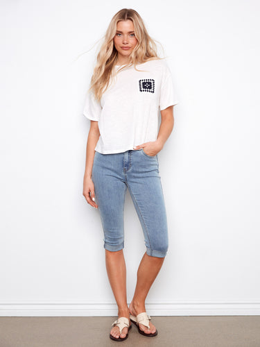 This soft organic cotton t-shirt features a stylish crochet pocket and a classic crew neckline by Charlie B.