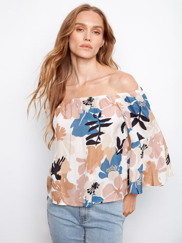 Adorned with a vibrant floral pattern, this blouse brings a fresh and lively feel to your wardrobe. By Charlie B.