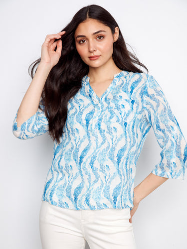 Blue patterned blouse with a stylish Henley neckline, perfect for casual outings. Designed by Charlie B.