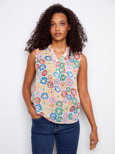 Floral top with a Henley neckline and colorful design, perfect for casual outings. Finished by Charlie B.