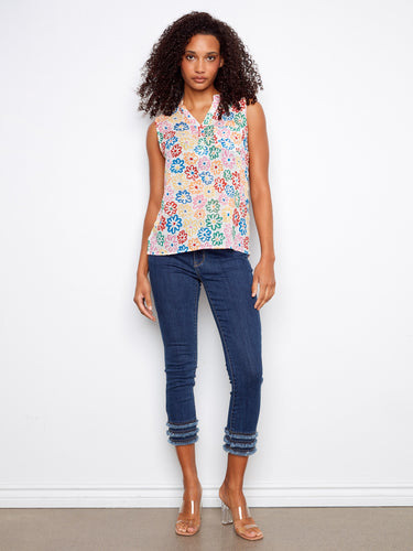 Vibrant sleeveless top featuring a half-button front and floral pattern, ideal for summer days. Styled by Charlie B.