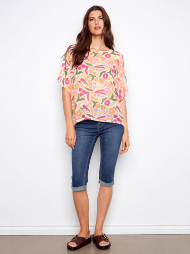 Vibrant abstract print blouse featuring a crew neckline and elbow-length dolman sleeves, crafted in a soft cotton blend by Charlie B.