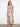 Floral dress featuring a V-neckline and vibrant colors, perfect for any occasion. Designed with elegance and style by Charlie B.