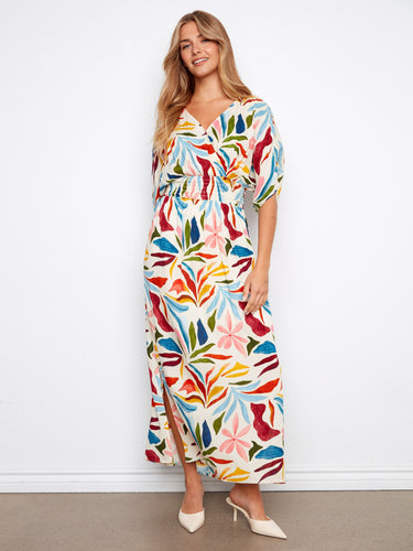 Floral dress featuring a V-neckline and vibrant colors, perfect for any occasion. Designed with elegance and style by Charlie B.