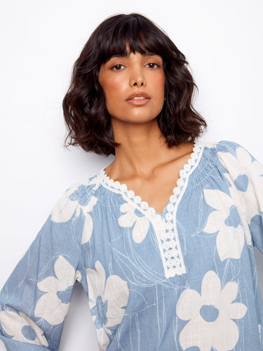 Chic floral top showcasing a notch neckline with crochet trim, offering a stylish touch to your everyday look by Charlie B.
