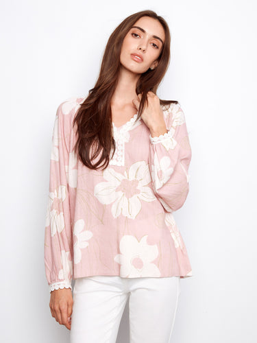 Floral blouse with a notch neckline, featuring crochet trim for added elegance. Perfect for casual outings. By Charlie B.