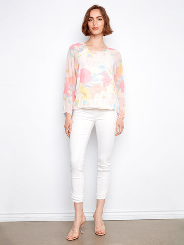 Elastic cuffs provide comfort and style in this beautifully designed floral blouse. By Charlie B.