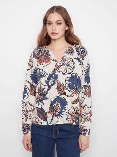 Floral blouse with a stylish notch neckline and raglan sleeves, crafted in soft viscose for comfort by Charlie B.