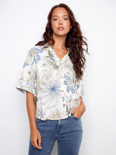Floral blouse with a Hawaiian print, featuring short sleeves with button tabs and chest pockets by Charlie B.