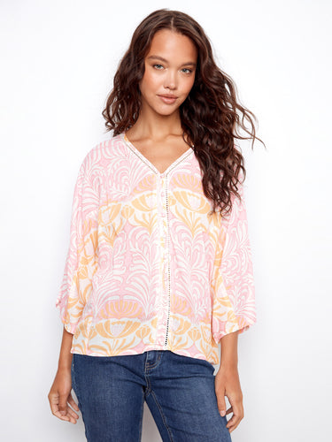 Chic top showcasing a V-neck design, perfect for casual outings. The subtle pattern adds elegance to any look by Charlie B.