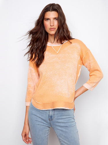100% cotton fabric ensures breathability in this fashionable orange top, making it a versatile wardrobe staple. By Charlie B.