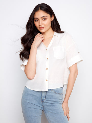 White shirt featuring a classic shirt collar, perfect for a polished look. The fabric is light and airy, ideal for warm days by Charlie B.